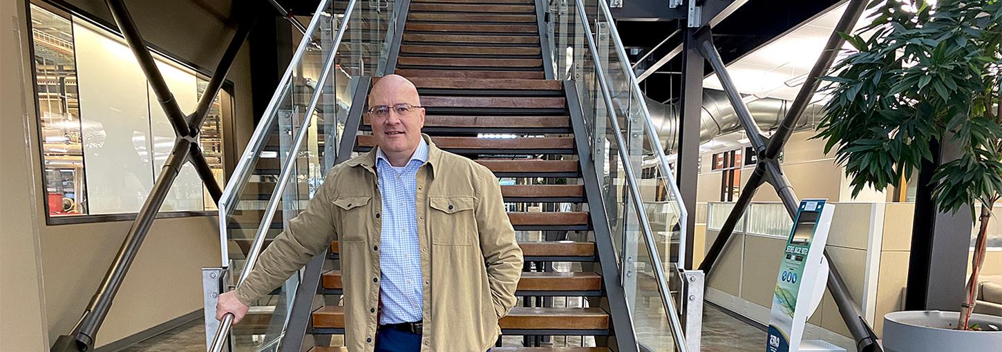 Skinner standing in front of  a staircase